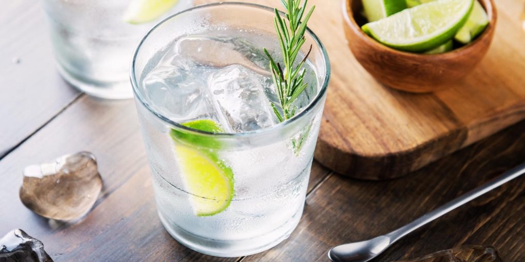 Refreshing Vodka Tonic served on ice with a rosemary and lime wedge garnish