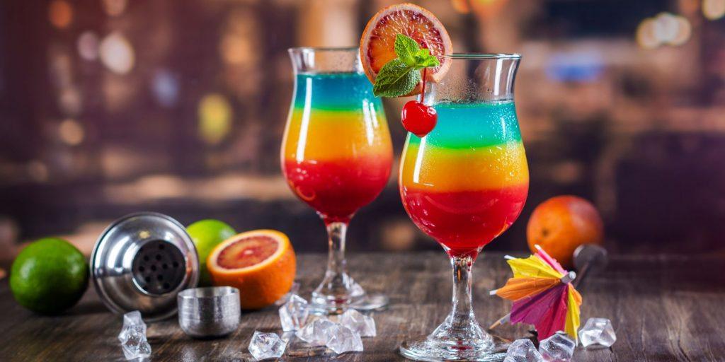 A vibrant Rainbow Layered Cocktail, a colourful and visually stunning drink perfect for festive occasions.