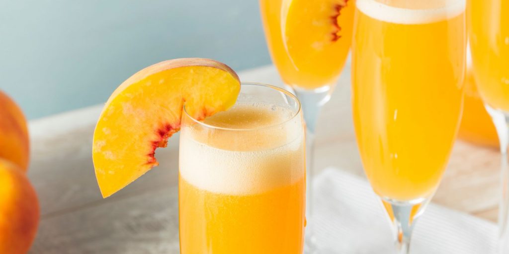 Close of up two Peachin' Mimosas in a light bright home kitchen