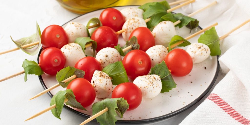 Close-up of a plate of Caprese breakfast skewers
