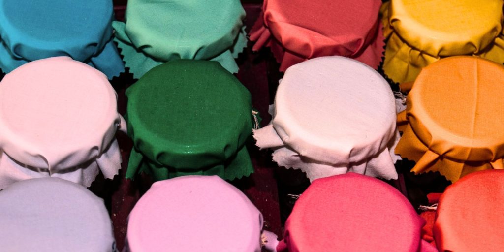 Top view of a variety of jars covered with cloth in the Fat Washing process