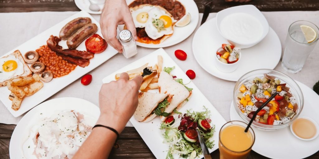 Top view of two friends enjoying a variety of brunch foods 