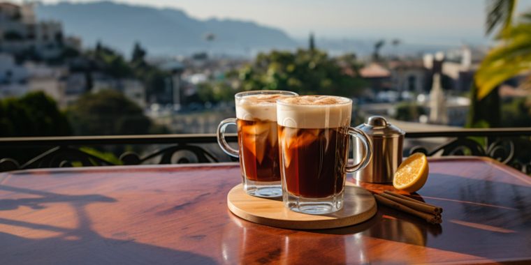 Wide angle shot of two Amaretto cocktails overlooking a typical Italian countryside scene on a sunny day from a balcony