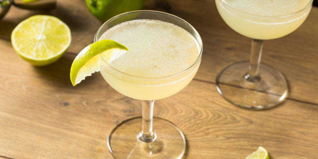 Close up top view of two Lime Daiquiris on a wooden surface in a light bright home environment
