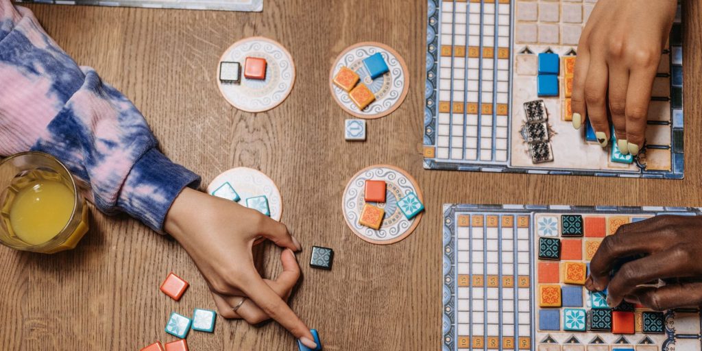 Top view of a group of friends playing board games at a New Year's Eve party