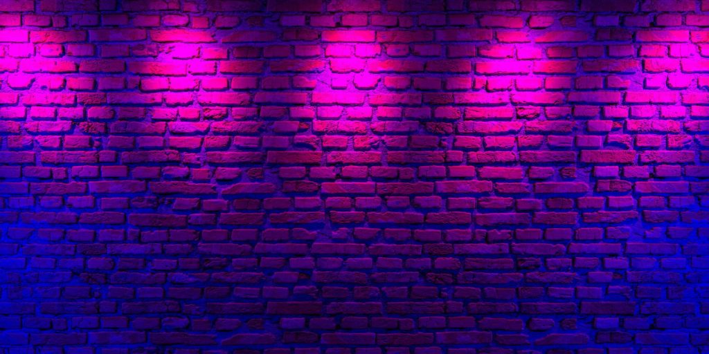 Wide shot of a wall decorated with neon lights for a glow party