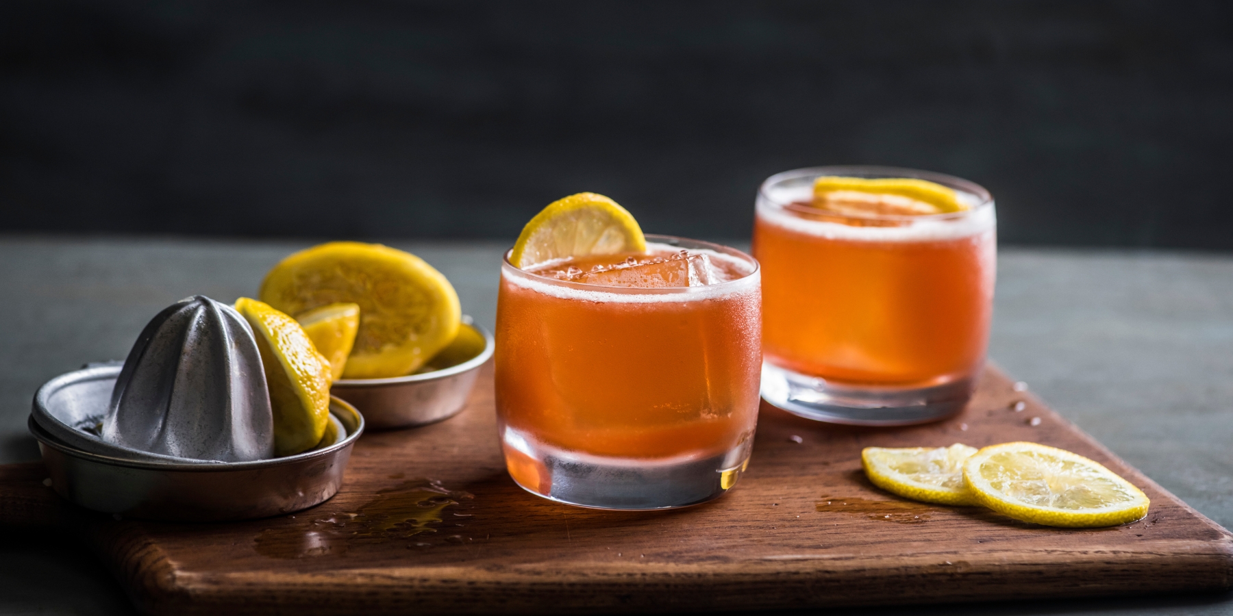 Two Paper Plane cocktails on the rocks with lime wheel garnish