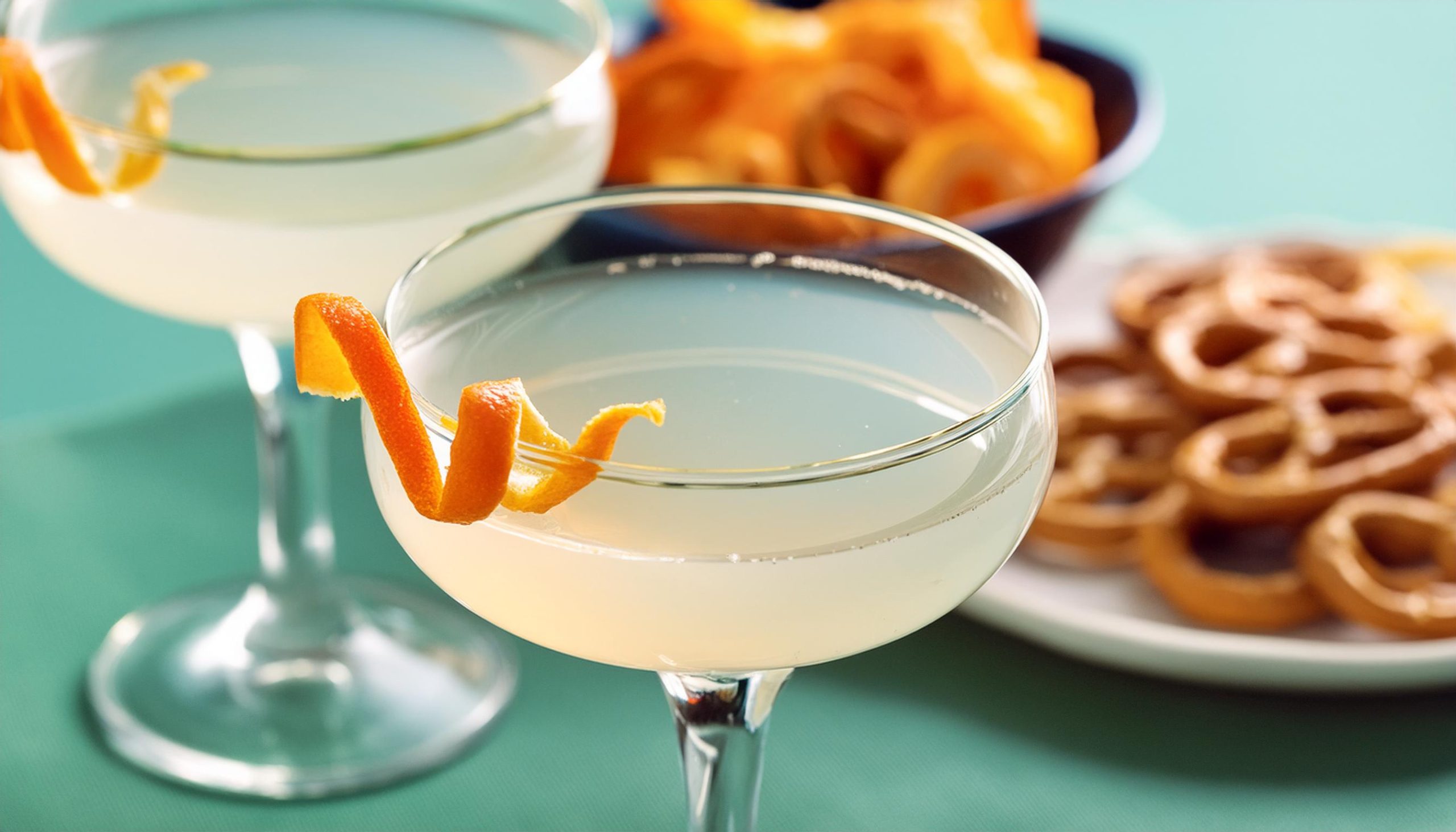 Close-up of two White Cosmos with orange twist garnish