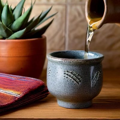 Pouring shot of mezcal into a copita