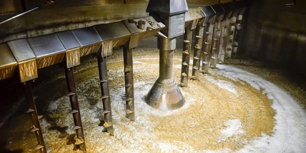 The inside of a whiskey mash tank with the soaked grains