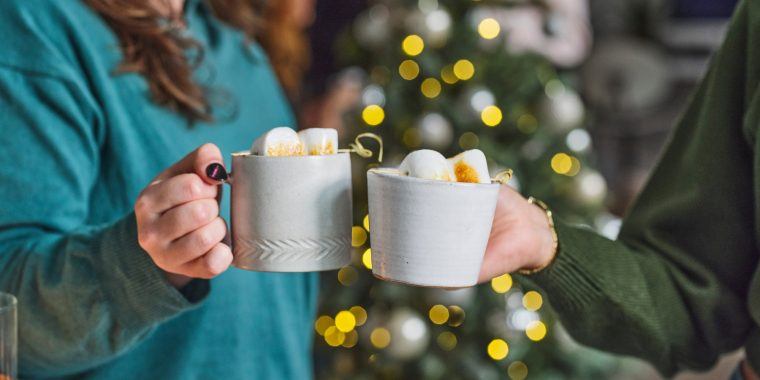 Friends clinking together mugs of Mexican Hot Chocolate