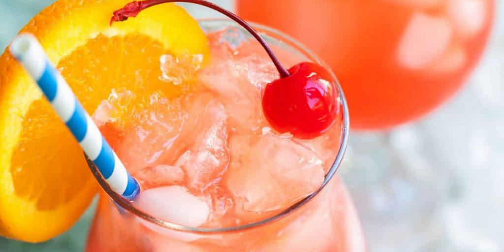 Close Up top view of Hurricane Cocktail garnished with orange wedge and maraschino cherry