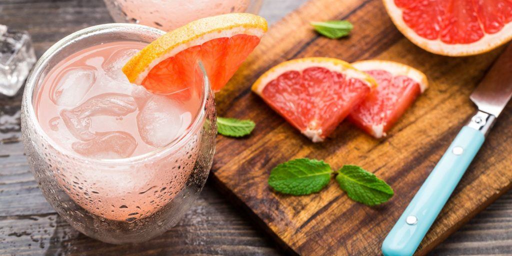 French Blonde Cocktail with Grapefruit wedges garnish on Stylish Chopping Board