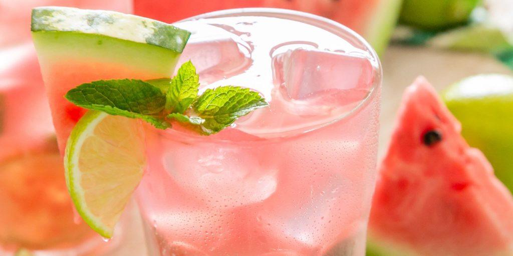 Close up of PInk Watermelon Gin Fizz with mint and lime