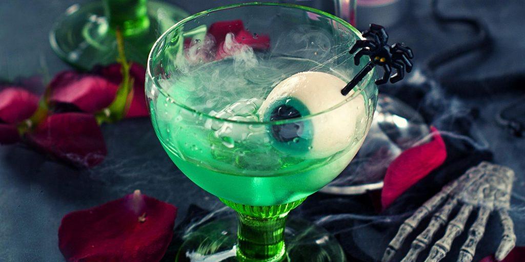Gory Green Halloween cocktail with halloween garnishes