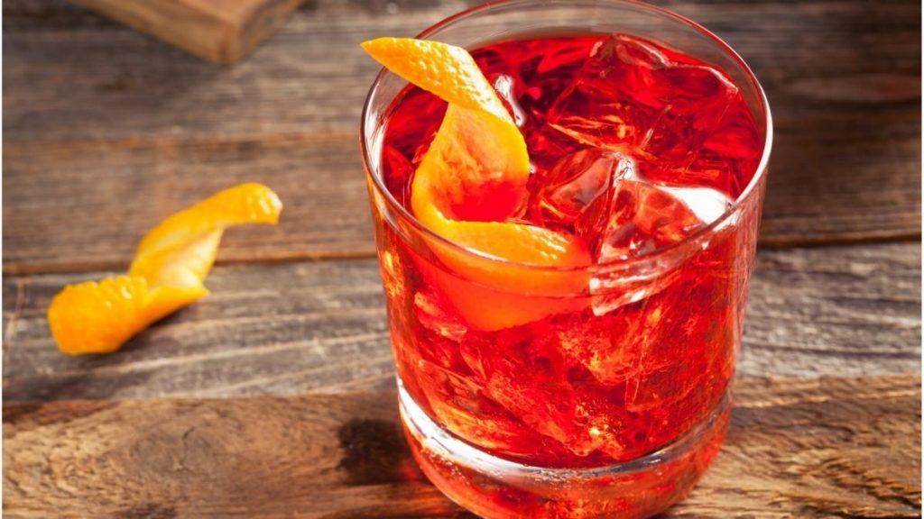 bright red negroni cocktail with orange twist