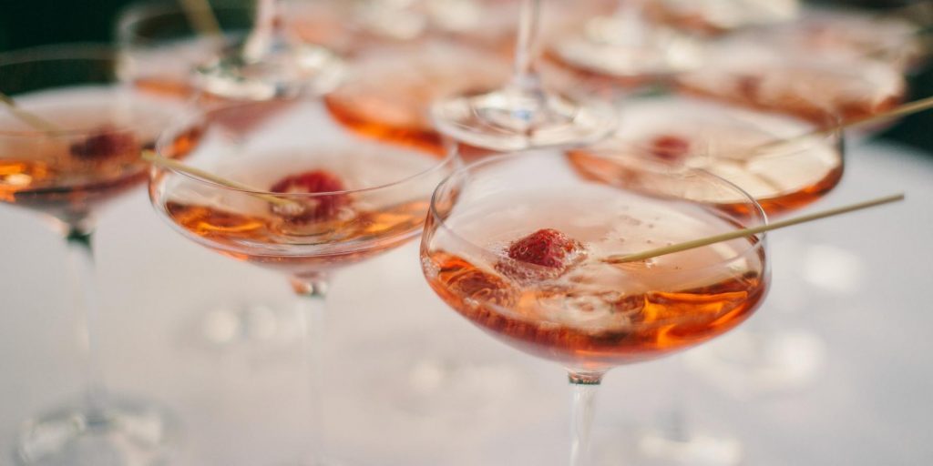 Sparkling Pink Champagne martinis served in coupes and garnished with berries