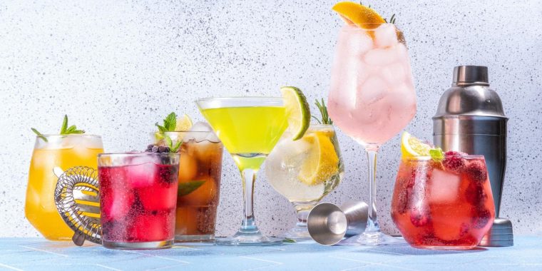 Multi-colored mocktails lined up in different glasses