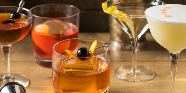 Front shot of five different cocktails on wooden table