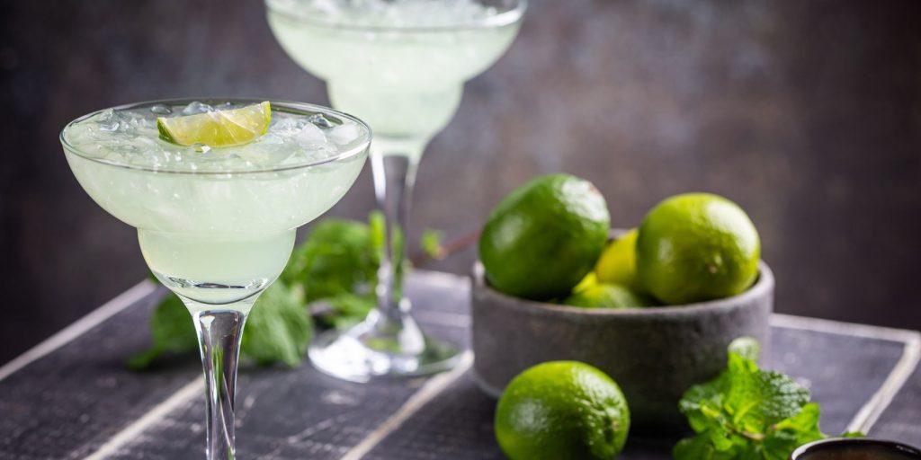 Virgin Margarita with a bowl of limes on wood