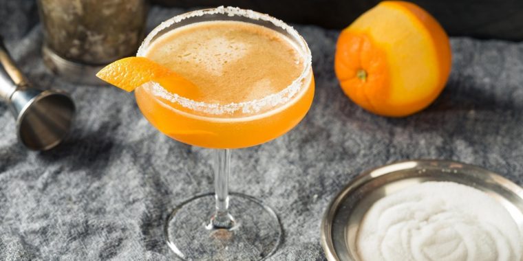 Top view of a Sidecar cocktail garnished with fresh orange peel