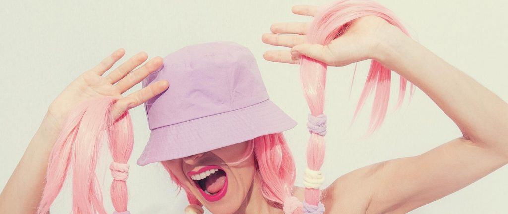 Woman with pink dyed hair wearing a bucket hat