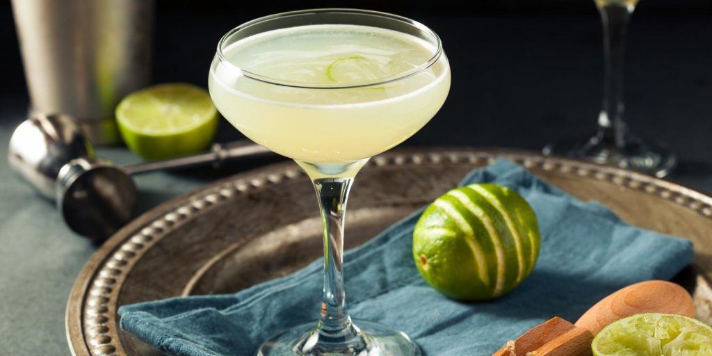 Refreshing vodka Gimlet in a coupe glass on a silver tray