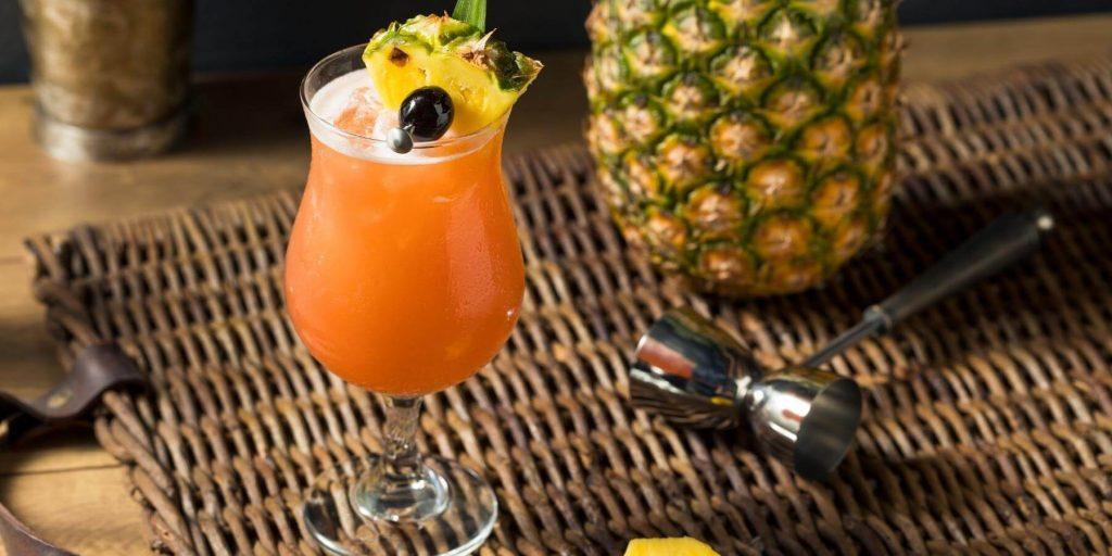 Singapore Sling Cocktail with cherry and pineapple garnish