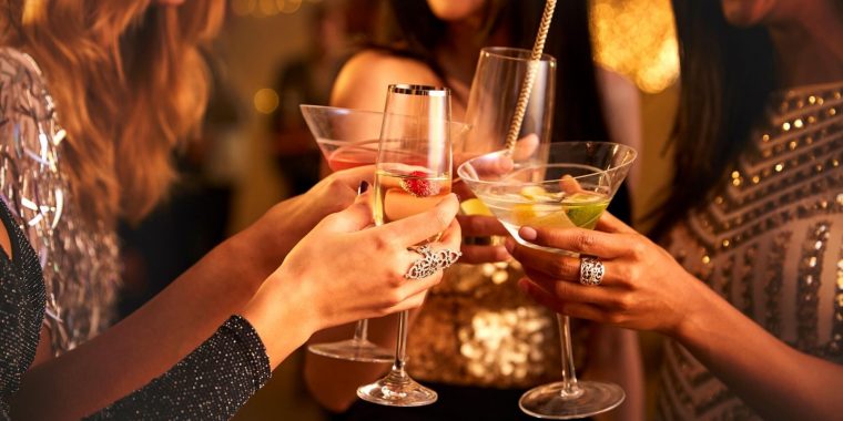 Women clinking cocktails together