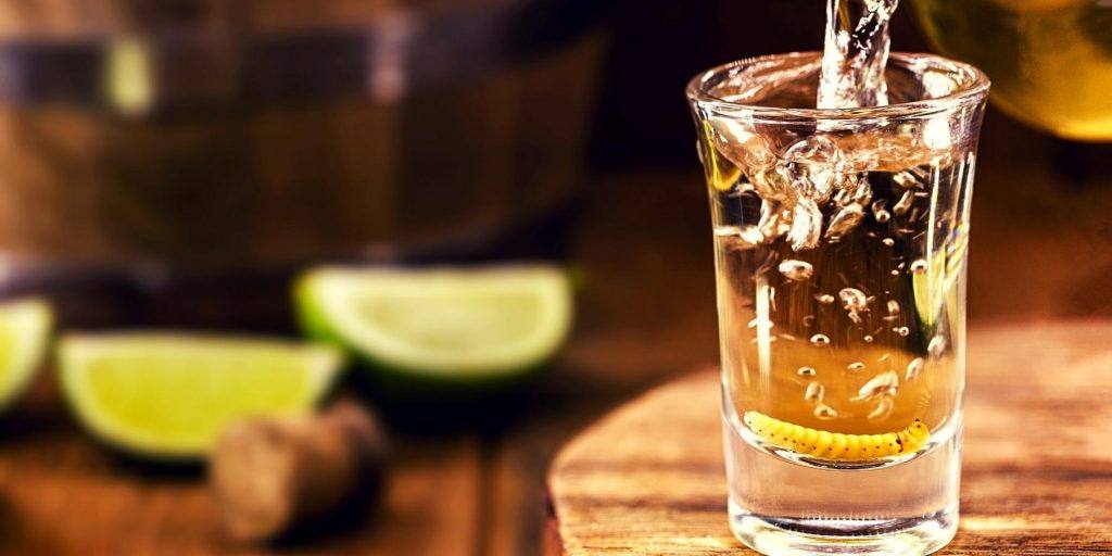 Shot of mezcal being poured into glass