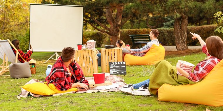 Friends enjoying outdoor cinema picnic