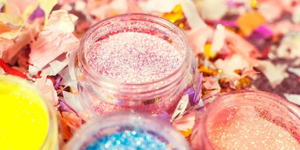 Small jars of edible glitter powder for sparkly cocktails