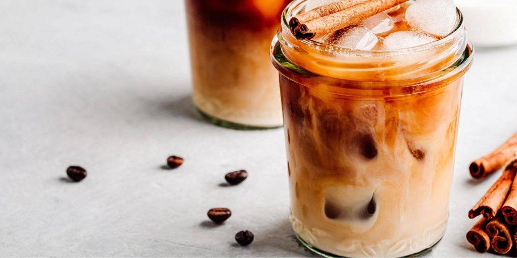 Coffee syrup in coffee cocktail served in a jar with cinnamon