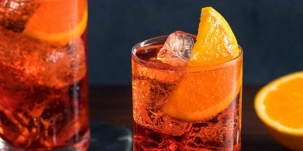 two americano cocktails garnished with orange slices