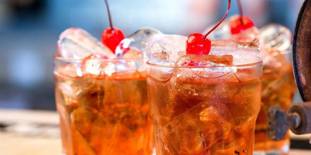 Three dark and stormy cocktails with cherries