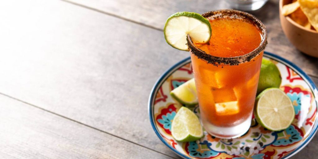 Michelada Beer Cocktail with tajin rim and lime