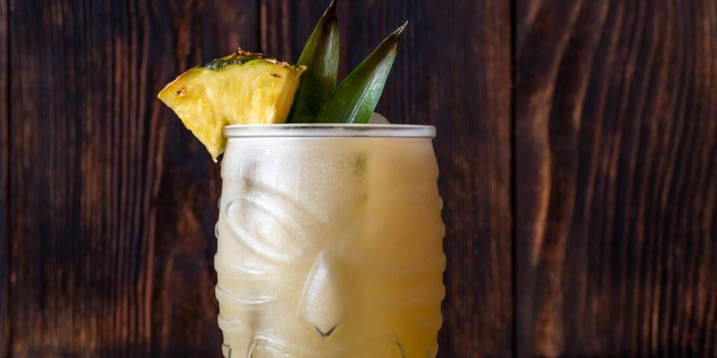 A Painkiller cocktail with pineapple fronds
