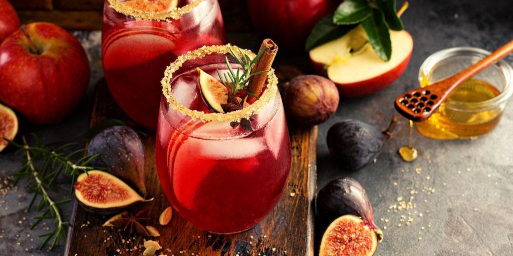Fall botanical cocktails with cinnamon and fig garnish