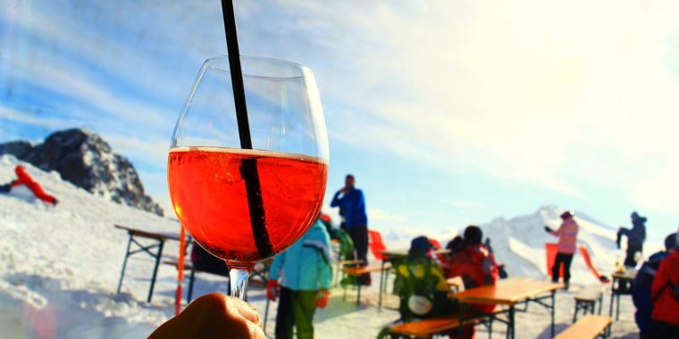 Aperol cocktail with ski slopes in the background