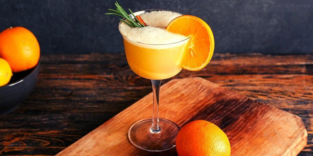 Japanese Whiskey Sour with orange and rosemary garnish