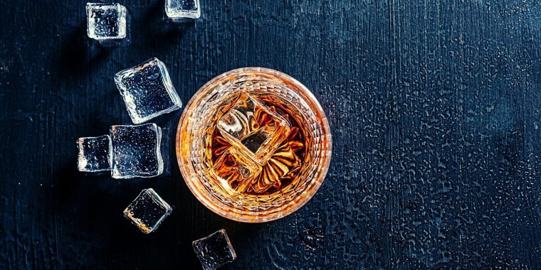 Top shot of Japanese whiskey drink with ice cubes