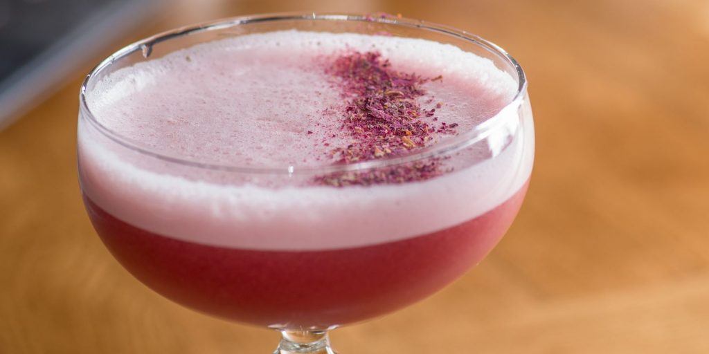 Crushed berry garnish on a frothy cocktail