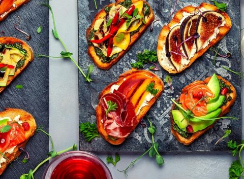 Top view of colorful Bruschetta appetizer with wine