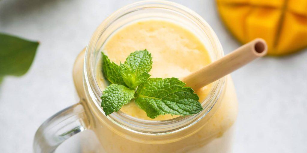 Overhead of a mango lassi cocktail with mint