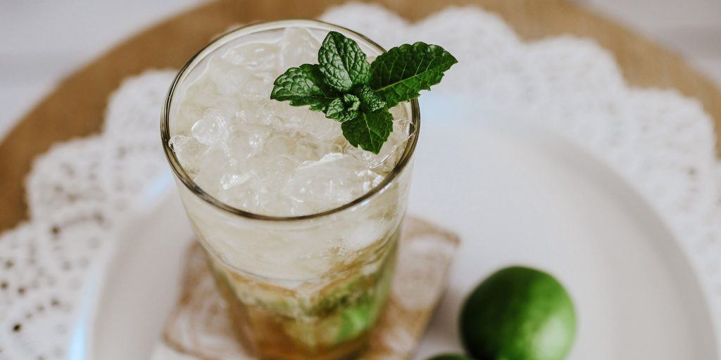 A crisp Apple Cider Mojito garnished with fresh mint leaves and apple slices.