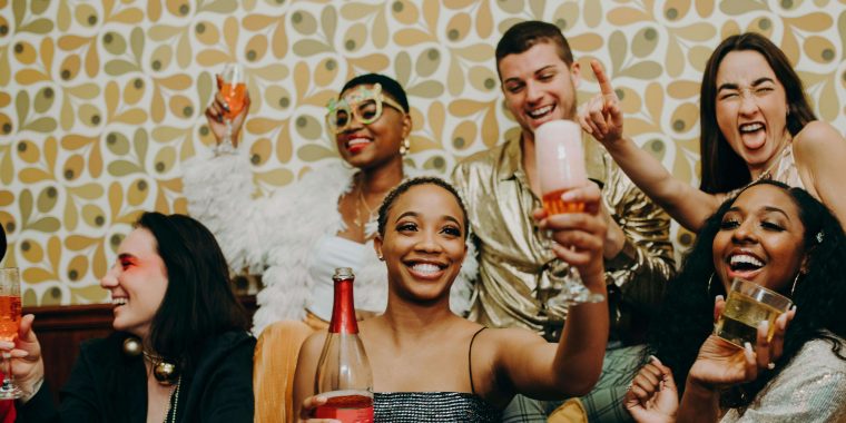 Friends posing for a photo holding their drinks