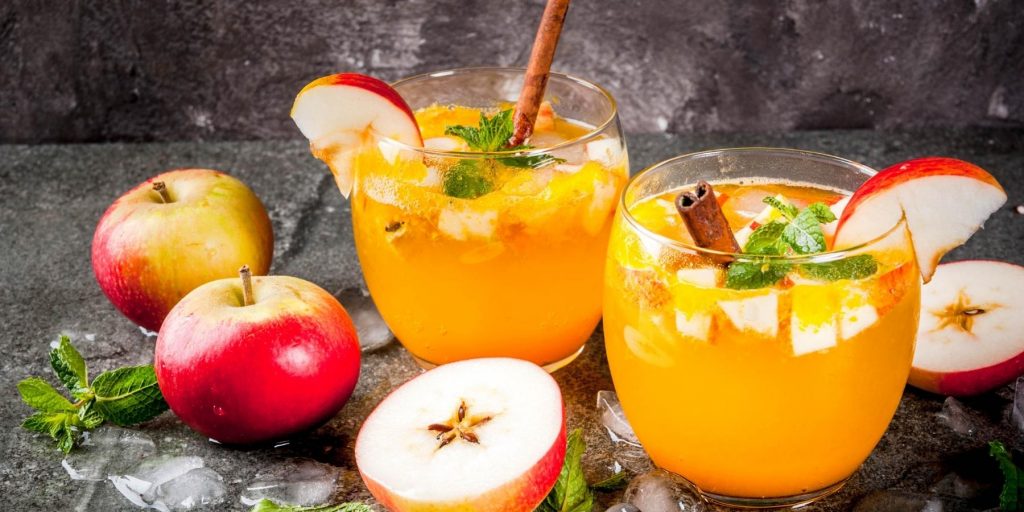 A refreshing Apple Cider Mojito garnished with fresh mint leaves and apple slices.