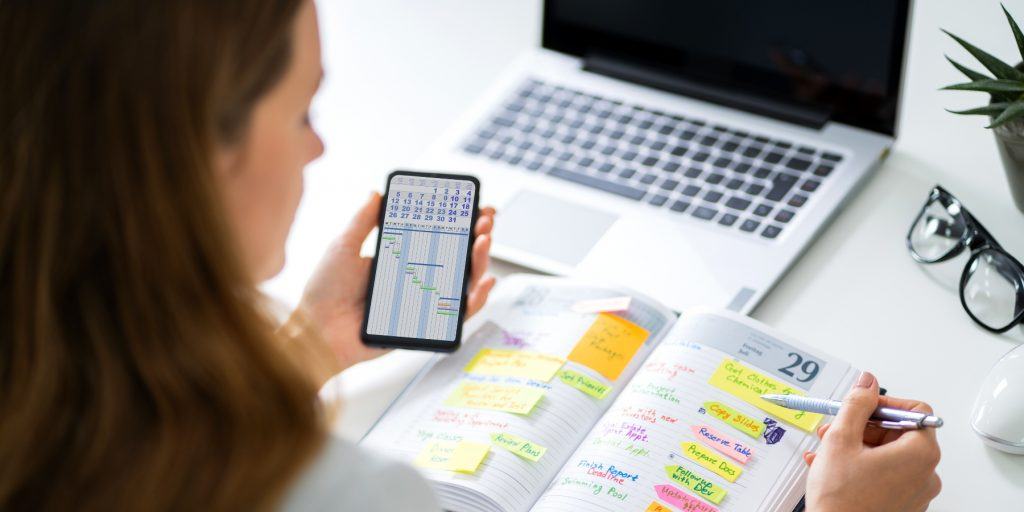 A woman planning dates in a calendar