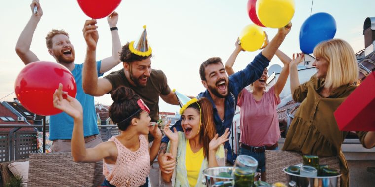 A group of friends in party hats celebrating