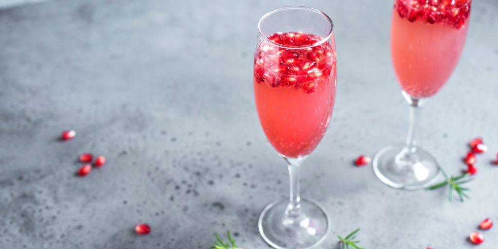 Two Cranberry Mimosa cocktails with cranberry garnish